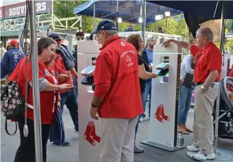  ?? CHRIS cHRISTO / HeRald STaFF FIle ?? FEELS LIKE A LIFETIME AGO: Fans have their tickets scanned while entering Fenway Park during the 2019 season.