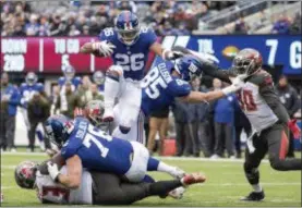  ?? JOHN BLAINE — FOR THE TRENTONIAN ?? Giants running back Saquon Barkley (26) gets through the line to score a touchdown against Tampa Bay during Sunday’s game at MetLife Stadium.