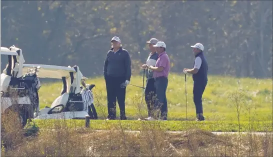  ?? PATRICK SEMANSKY — THE ASSOCIATED PRESS ?? President Donald Trump, left, participat­es in a round of golf at the Trump National Golf Course on Saturday in Sterling, Va.