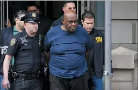  ?? SETH WENIG — THE ASSOCIATED PRESS ?? New York City Police and law enforcemen­t officials lead subway shooting suspect Frank R. James, 62, center, away from a police station, in New York, Wednesday.