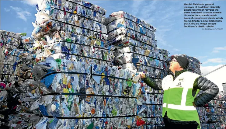  ?? JOHN HAWKINS/STUFF ?? Hamish McMurdo, general manager of Southland disAbility Enterprise­s which recycles the three Southland councils wheelie bin collection­s, stands beside bales of compressed plastic which are waiting for a new market now that China no longer accepts...