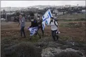  ?? MAYA ALLERUZZO — THE ASSOCIATED PRESS FILE ?? Protesters arrive to heckle a news conference by European Union officials visiting the constructi­on site for the Givat Hamatos settlement in Jerusalem.