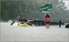  ?? MARK MULLIGAN — HOUSTON CHRONICLE VIA AP ?? Two kayakers try to beat the current pushing them down an overflowin­g Brays Bayou along S. Braeswood in Houston, Texas, Sunday. The bayou sits alongside a University of Houston dorm where Cardinal O’Hara grad Hanna Blewett lives.