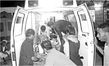  ??  ?? Yemeni doctors off load a man from an ambulance after he was being injured in reported air raids by the Saudi-led coalition that hit a Bedouin tent in Rahal in the Huthis’ northern heartland of Saada province. — AFP photo