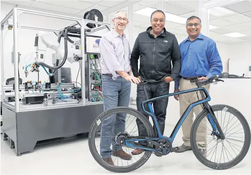  ?? PHOTOS BY REUTERS ?? FROM LEFT Arevo Labs CEO Jim Miller, CTO Wiener Mondesir, and chairman and co-founder Hemant Bheda stand for a photo with the company’s 3D-printed carbon fibre commuter bike in Santa Clara, California.