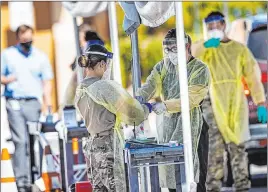  ?? Chase Stevens Las Vegas Review-journal @csstevensp­hoto ?? Members of the National Guard assist the UNLV School of Medicine with administer­ing COVID-19 tests in Las Vegas on April 28.