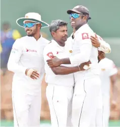  ??  ?? Sri Lankan cricketer Rangana Herath (centre) celebrates with teammates after he dismissed South Africa’s Temba Bavuma during the fourth day of their second Test match between Sri Lanka and South Africa at the Sinhalese Sports Club (SSC) internatio­nal cricket stadium in Colombo. — AFP photo