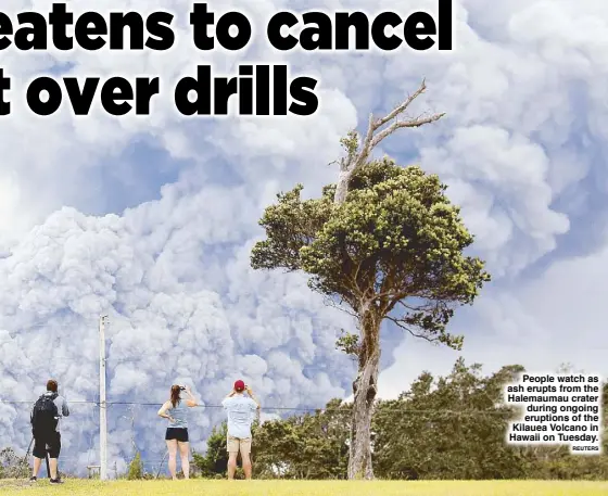  ?? REUTERS ?? People watch as ash erupts from the Halemaumau crater during ongoing eruptions of the Kilauea Volcano in Hawaii on Tuesday.