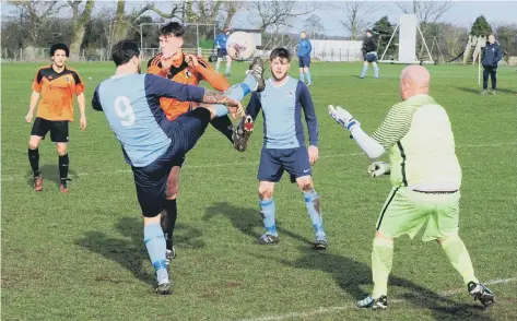  ??  ?? Edgehill’s Kieran Link flies into a challenge with a Whitby defender with keeper Paul Cull advancing off his line