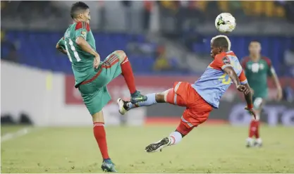  ?? —AP ?? OYEM: Congo’s Lomalisa Mutambala, right, vies with Morocco’s Faycal Fajr, left, during their African Cup of Nations Group C soccer match between Congo and Morocco at the Stade de Oyem in Oyem, Gabon, Monday.