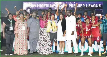  ??  ?? Women Affairs Minister, Mrs. Pauline Tallen, presenting the 2018/19 NWPL Super 4 trophy to Captain of Rivers Angels, Tochi Oluehi shortly after defeating Confluence Queens 1-0 to emerge champions…yesterday