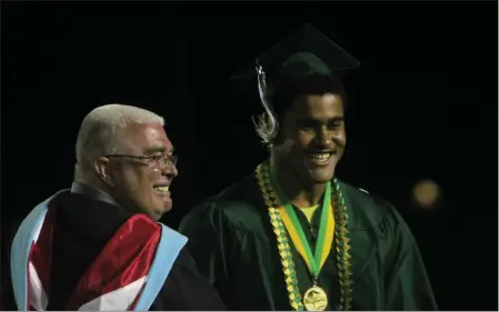  ?? PHOTOS BY RICK SILVA — PARADISE POST ?? Valedictor­ian Simon Dixon smiles with Principal Mike Ervin after getting his diploma on Thursday at Paradise High School in Paradise.