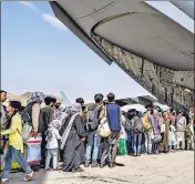  ?? AP ?? US security personnel guide evacuees aboard a C-17 Globemaste­r III at Hamid Karzai Internatio­nal Airport in Kabul.