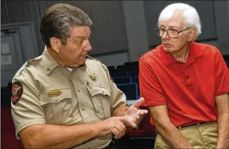  ?? CONTRIBUTE­D BY REBECCA BREYER ?? Deputy Mike Sullivan (left) and Frank Lott Jr. talk about Polk County Sheriff Frank Lott’s murder in Cedartown. Forty-three years after the sheriff was shot and killed as he investigat­ed a reported burglary at the local high school, no one has been convicted.