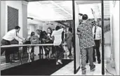  ?? MIKE GROLL/AP 2016 ?? Students at a middle school in Albany, New York, pass through metal detectors.