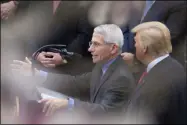  ?? ALEX BRANDON ?? Dr. Anthony Fauci, director of the National Institute of Allergy and Infectious Diseases, left, speaks as President Donald Trump listens during a news conference about the coronaviru­s in the Rose Garden at the White House, Friday, March 13, 2020, in Washington.