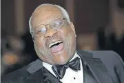  ?? [ASSOCIATED PRESS FILE PHOTO] ?? Supreme Court Justice Clarence Thomas laughs while talking with other guests at The Federalist Society’s Annual Dinner on Nov. 10, 2011, in Washington. During confirmati­on hearings, Thomas faced questions about former colleague Anita Hill’s claims that...