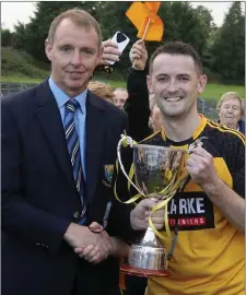  ??  ?? Wicklow County Board Vice Chairman Martin Fitzgerald presents the Darcy Sands IFC cup to Ashford captain Brendan Manning.