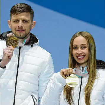  ?? Foto: Imago ?? Michalina Lisowa (links ihr Guide Alexey Ivanov) hat in Pyeongchan­g Biathlon Gold bei den Sehbehinde­rten gewonnen. Dass sie überhaupt starten durfte, ist umstritten, die Russin steht unter Dopingverd­acht.