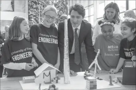  ?? FRANK GUNN, THE CANADIAN PRESS ?? Prime Minister Justin Trudeau talks with students working on designs for future cities, in Toronto on Tuesday.