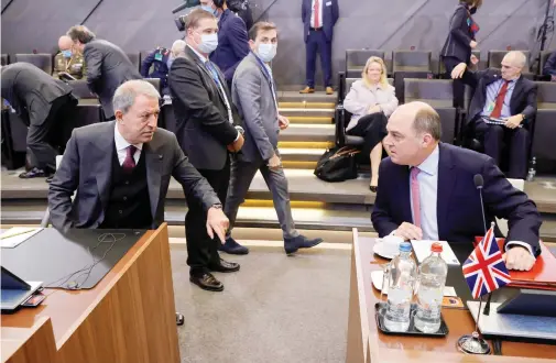  ?? Reuters ?? Turkey’s Defense Minister Hulusi Akar talks with Britain’s Defense Secretary Ben Wallace at NATO Defense Ministers’ meeting in Brussels, Belgium.