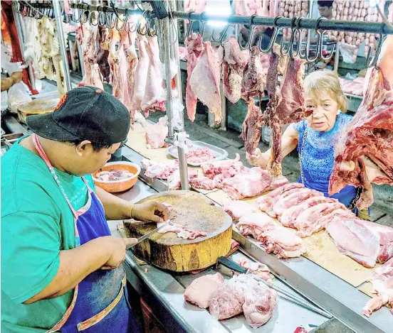  ?? PHOTOGRAPH BY KING RODRIGUEZ FOR THE DAILY TRIBUNE ?? A SENIOR citizen buys meat in a wet market in Sta. Ana, Manila on Tuesday despite its still high price, amid the report of the Philippine Statistics Authority stating that the inflation rate in January 2024 eased further to 2.8 percent, well within the government’s target range of 2 to 4 percent.