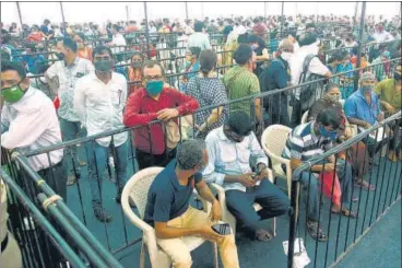  ?? ANI ?? People wait to receive a dose of the vaccine against Covid-19 at BKC Jumbo Vaccinatio­n Centre, in Mumbai on Tuesday.