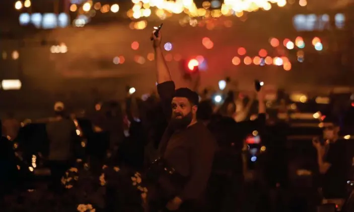  ?? Photograph: Sergei Gapon/AFP/Getty Images ?? A man holding up a phone with a torch during a Minsk rally of opposition supporters, who accuse Lukashenko of falsifying the polls in the presidenti­al election.