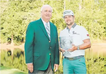  ??  ?? Augusta National Golf Club vice-chairman Joe Ford poses with Ryan Moore of the United States after Moore won the 2014 Par 3 Contest prior to the start of the 2014 Masters Tournament at Augusta National Golf Club in Augusta, Georgia. — AFP photo