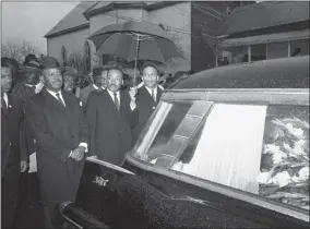  ?? ASSOCIATED PRESS ?? In this March 1, 1965, photo, the Rev. Martin Luther King Jr. leads a procession behind the casket of Jimmie Lee Jackson during funeral rites at Marion, Ala. From left, John Lewis, the Rev. Ralph Abernathy, King and the Rev. Andrew Young. In 1965, Jackson was fatally shot at a protest in Marion. It was that killing that sent hundreds of people to Selma for a march at the Edmund Pettus Bridge two weeks later.