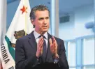  ?? Rich Pedroncell­i / Associated Press ?? Newsom is drawing fires for a contract for protective masks.