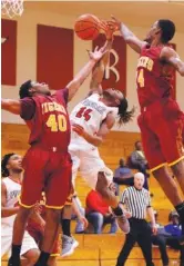  ?? STAFF PHOTO BY DOUG STRICKLAND / ?? East Ridge’s Solomon Taylor, center, tries to rebound against Howard’s Telijah Snow, left, and Daniel Burks during their basketball tournament game at East Ridge High School on Friday.