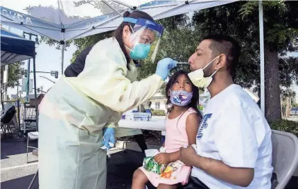  ?? CLIFFORD OTO/USA TODAY NETWORK ?? Katrina Nguyen tests Juan Cisneros, with daughter Jaylah, 5, in Lodi, Calif.