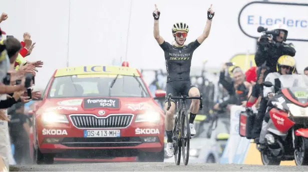  ?? Christophe Ena ?? ●● Bury’s Simon Yates celebrates as he crosses the finish line to win the fifteenth stage of the Tour de France. See report inside