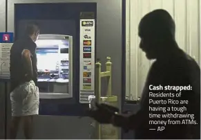  ??  ?? Cash strapped: Residents of Puerto Rico are having a tough time withdrawin­g money from ATMs. — AP