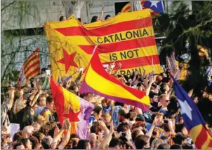  ?? PAU BARRENA/AFP ?? Protesters gather during a demonstrat­ion in Barcelona during a general strike in Catalonia on Tuesday.