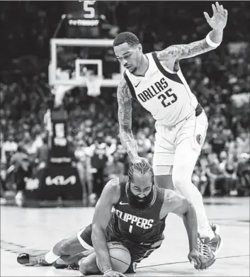  ?? Robert Gauthier Los Angeles Times ?? CLIPPERS guard James Harden stumbles in front of Mavericks forward P.J. Washington during the second half of L.A.’s 109-97 victory over Dallas in Game 1 of their best-of-seven playoff series at Crypto.com Arena.