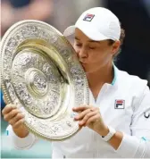  ?? AP ?? Ash Barty poses with the championsh­ip trophy after winning the singles final at Wimbledon.