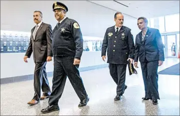  ?? CAMILLE FINE/CHICAGO TRIBUNE ?? Interim police Superinten­dent Charlie Beck, from left, outgoing Superinten­dent Eddie Johnson, Deputy Superinten­dent Anthony Riccio and Mayor Lori Lightfoot head to a meeting at Chicago Police Headquarte­rs on Friday.