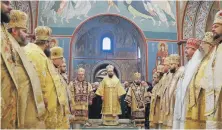  ?? EPA ?? The new head of the Ukrainian Orthodox Church, centre, leads the first liturgy at St Mikhaill Cathedral in Kiev