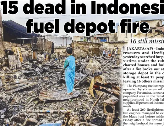  ?? AP ?? A boy stands in the remains of a burnt house in a residentia­l area in Plumpang, north Jakarta yesterday, after a fire at a nearby state-run fuel storage depot run by energy firm Pertamina.