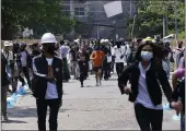  ?? THE ASSOCIATED PRESS ?? Anti-coup protesters abandon their makeshift barricade and run as policemen charge in Yangon, Myanmar, on Friday.