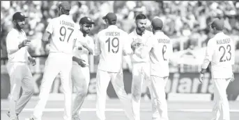  ?? ?? Fourth Test - Narendra Modi Stadium, Ahmedabad, India - March 6, 2021. India's captain Virat Kohli and his teammates congratula­te each other after they beat England. REUTERS/Amit Dave/File Photo