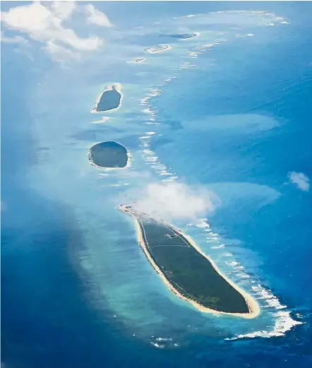  ?? — AFP ?? Maritime dispute: An aerial view of Qilianyu islands in the Paracel chain, which China considers part of Hainan province.