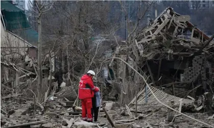  ?? ?? A medical worker comforts a woman at the site of Russia’s air attack, in Zaporizhzh­ia, Ukraine, on Friday. Photograph: Andriy Andriyenko/AP