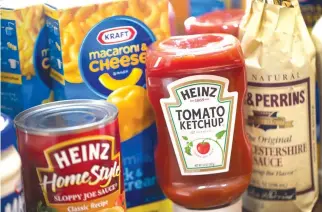  ??  ?? THIS FILE PHOTO taken on March 25, 2015 shows a photo illustrati­on of Kraft and Heinz products in Chicago, Illinois. US food giant Kraft Heinz has dropped its bid to buy Unilever days after it rejected a $143 billion buyout offer, the companies said on...