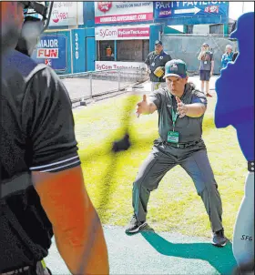  ?? Eva Russo Richmond Times-dispatch ?? Umpire Jen Pawol works with students during MLB baseball umpire camp in Richmond, Va., in 2022.