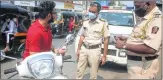  ??  ?? Police imposing fine on a scooterist for not wearing a mask in city on Monday. (Photo: BL Soni)