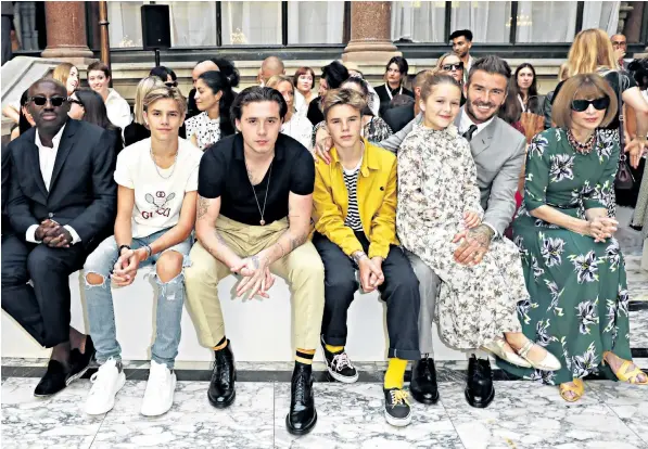  ??  ?? The Beckham family at Victoria Beckham’s show, including David with daughter Harper, sons Romeo, Brooklyn and Cruz, alongside British and American Vogue editors Edward Enninful, left, and Anna Wintour, right