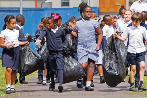  ?? ?? We’re on the march! Pupils at St Luke’s primary school in Canning Town, east London, join the great pick up yesterday